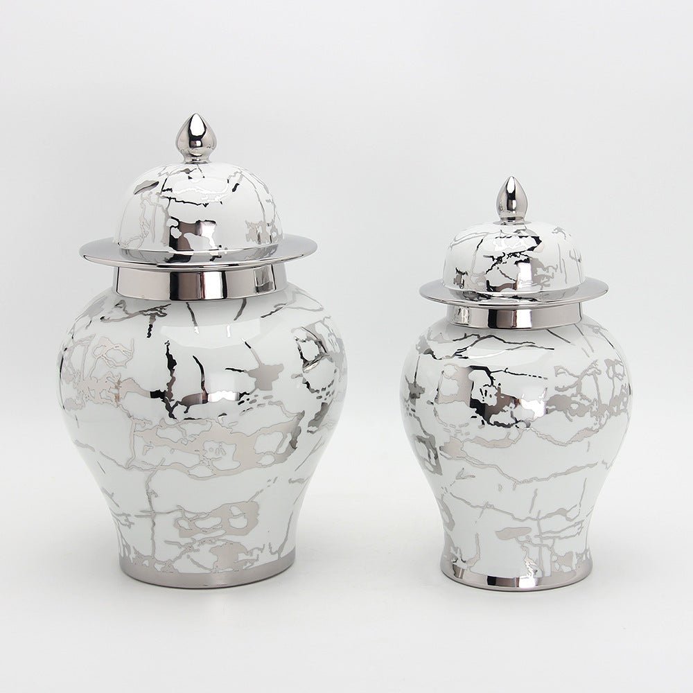 a group of three vases sitting on top of a table