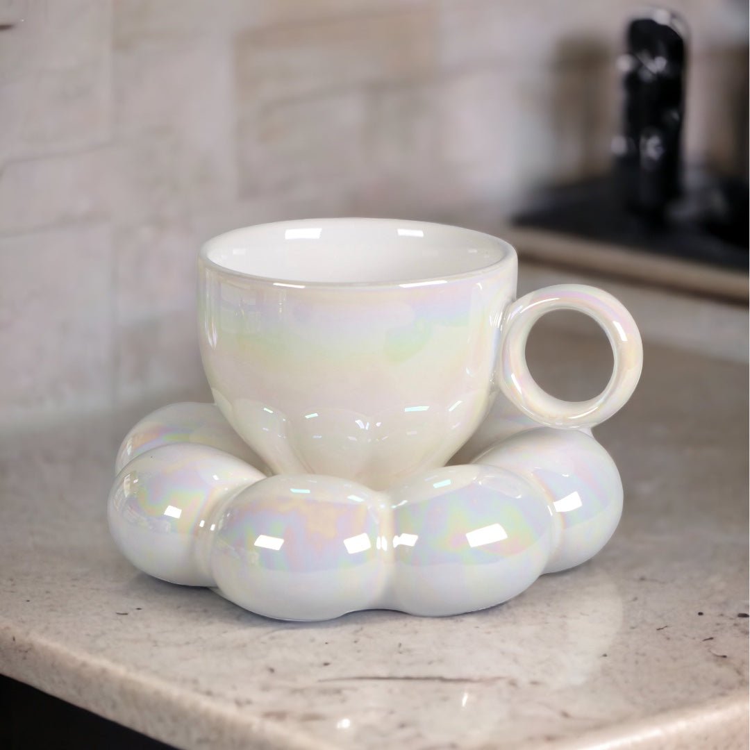 a cup of coffee sitting next to a white cup