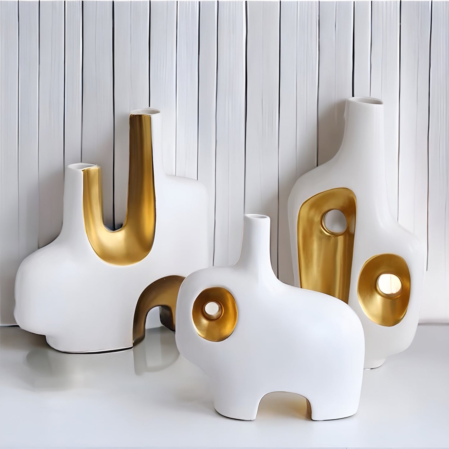 a couple of white vases sitting on top of a table