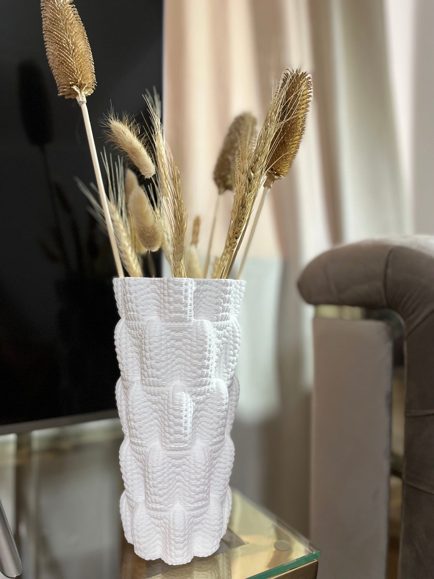 a glass vase with some flowers in it