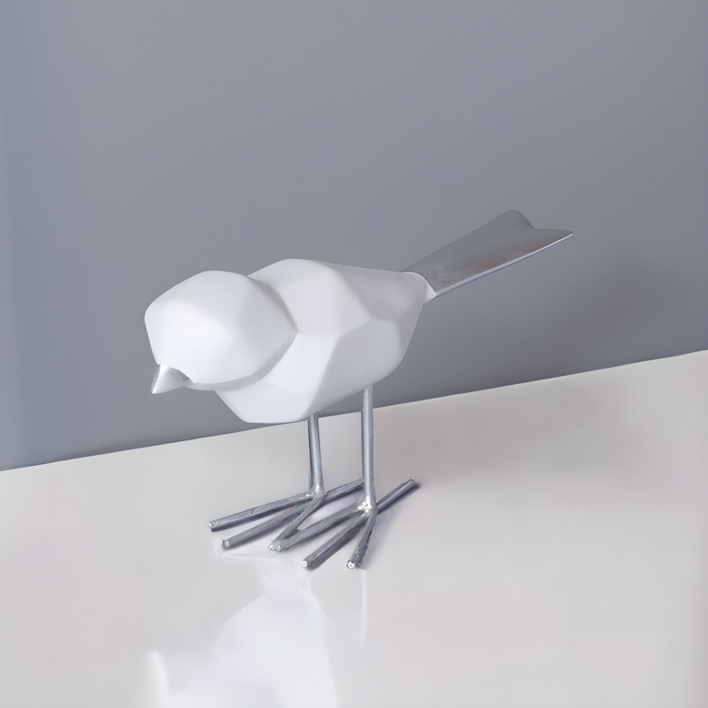 a white bird sitting on a window sill