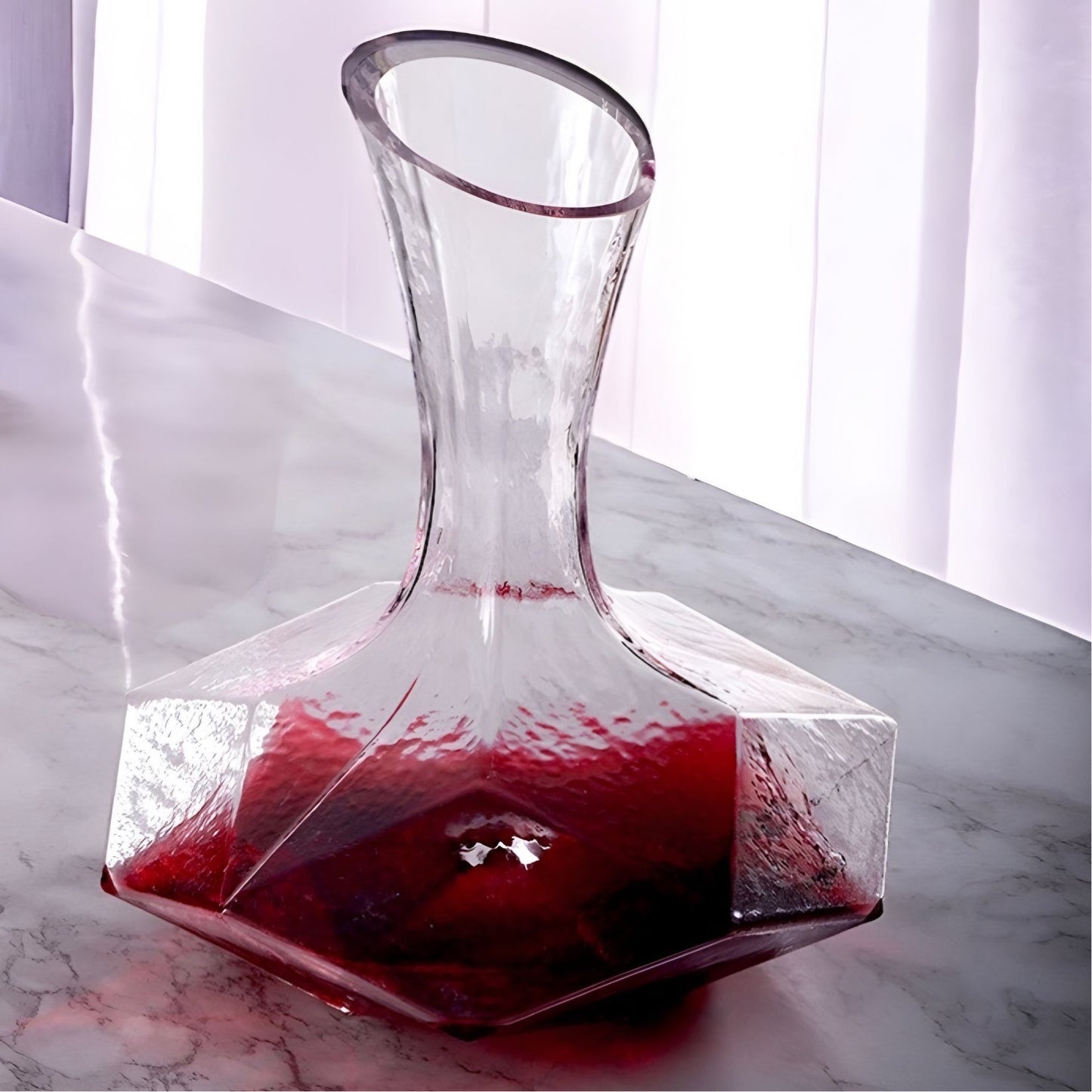 a glass vase with a red rose in it