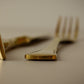 a pair of scissors sitting on top of a white table 