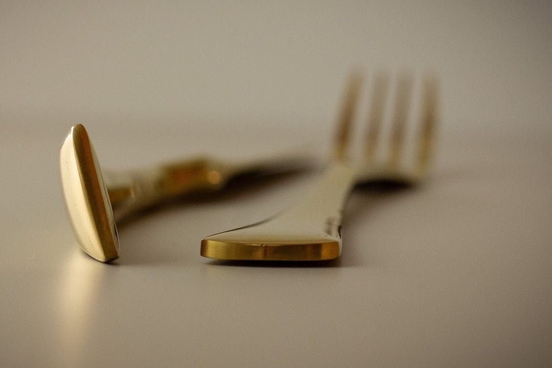 a pair of scissors sitting on top of a white table 