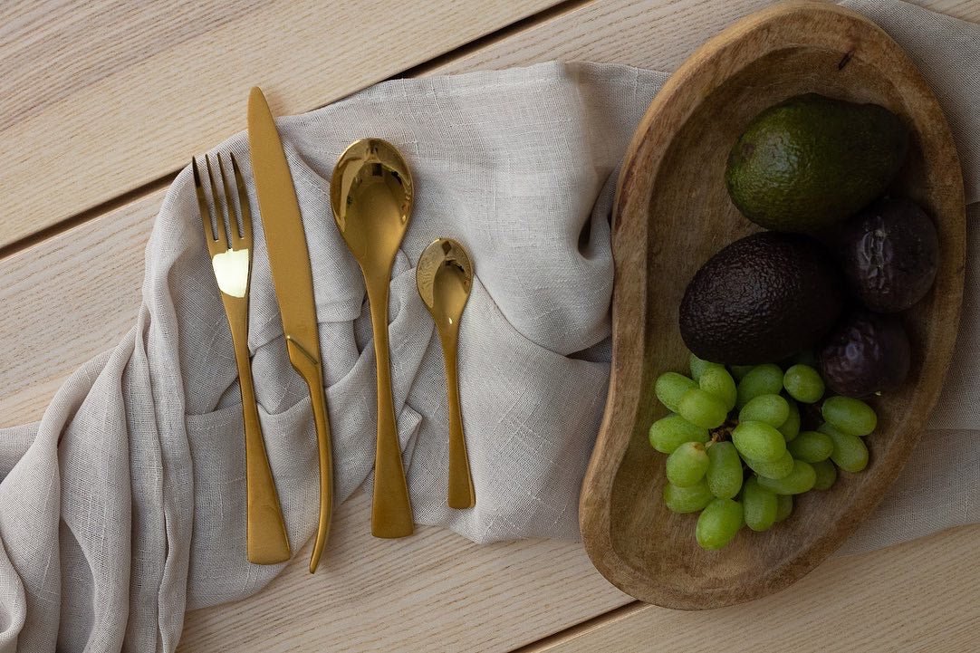 a table topped with a bowl of fruit and vegetables 