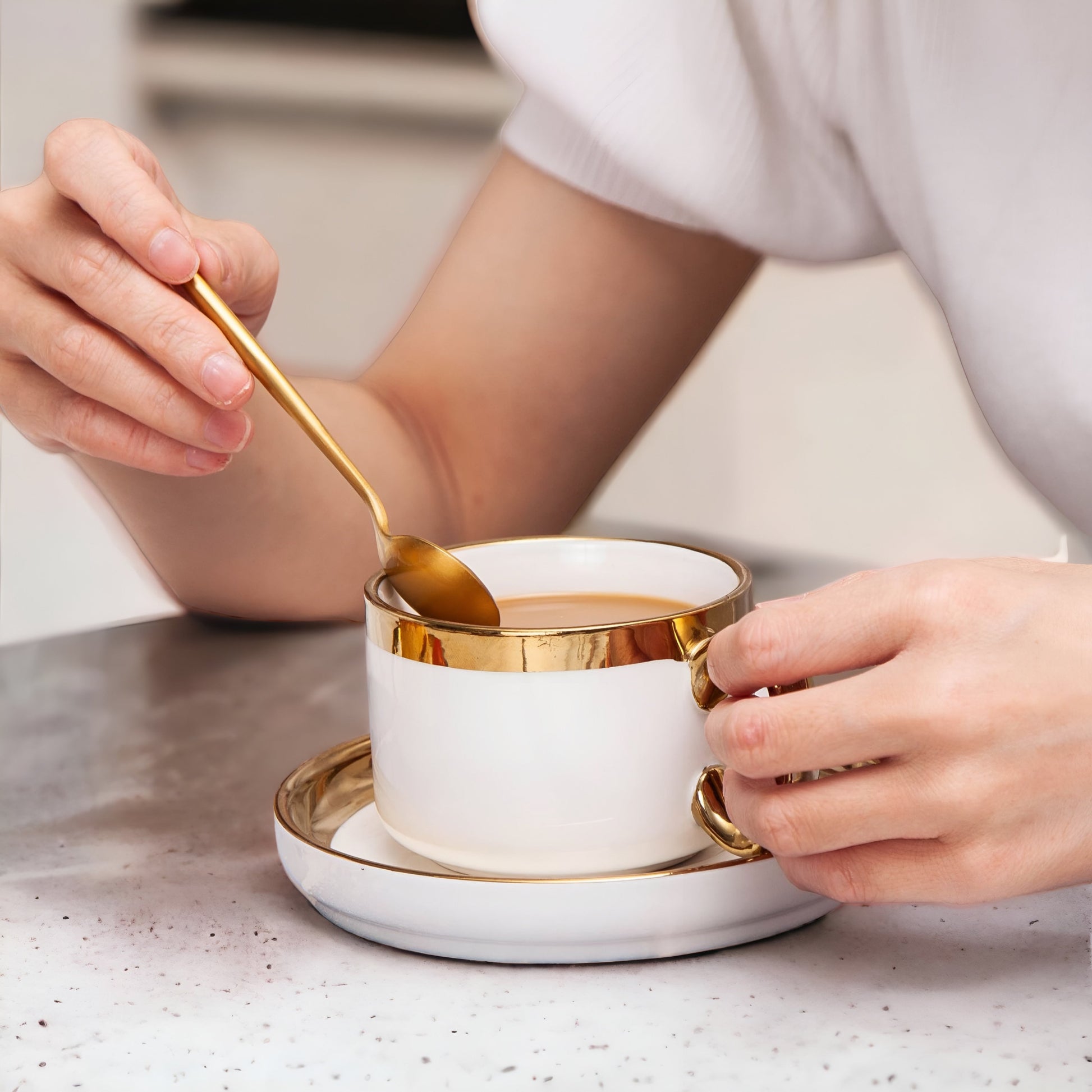 a close up of a person holding a cup of coffee 