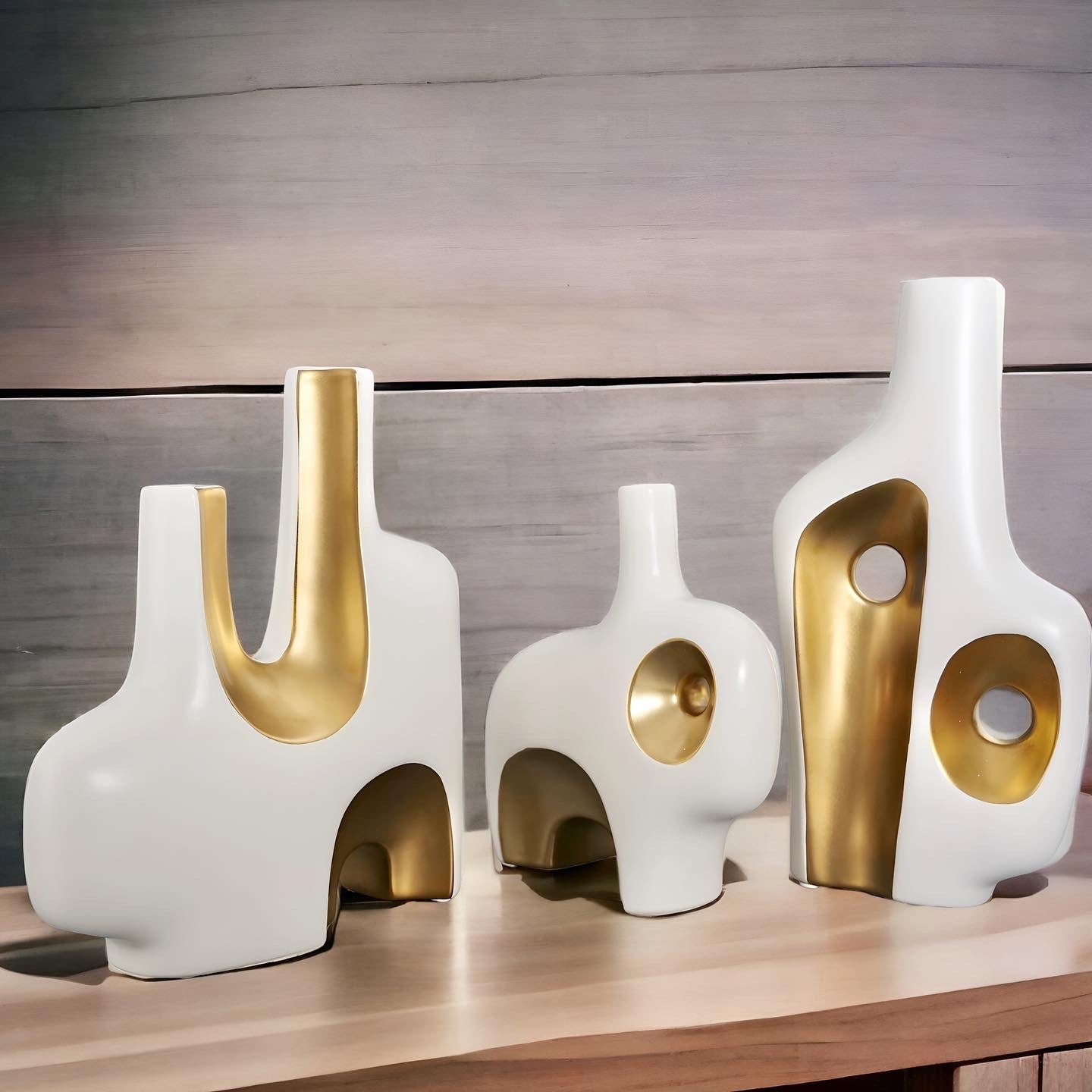 a couple of white vases sitting on top of a table 