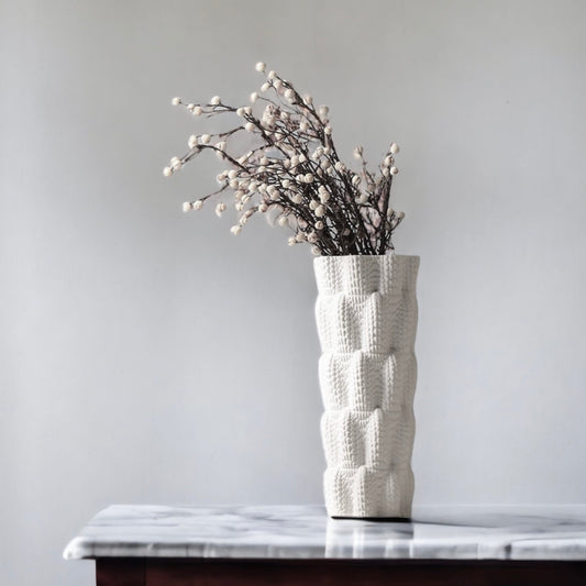 a vase of flowers sitting on a table 