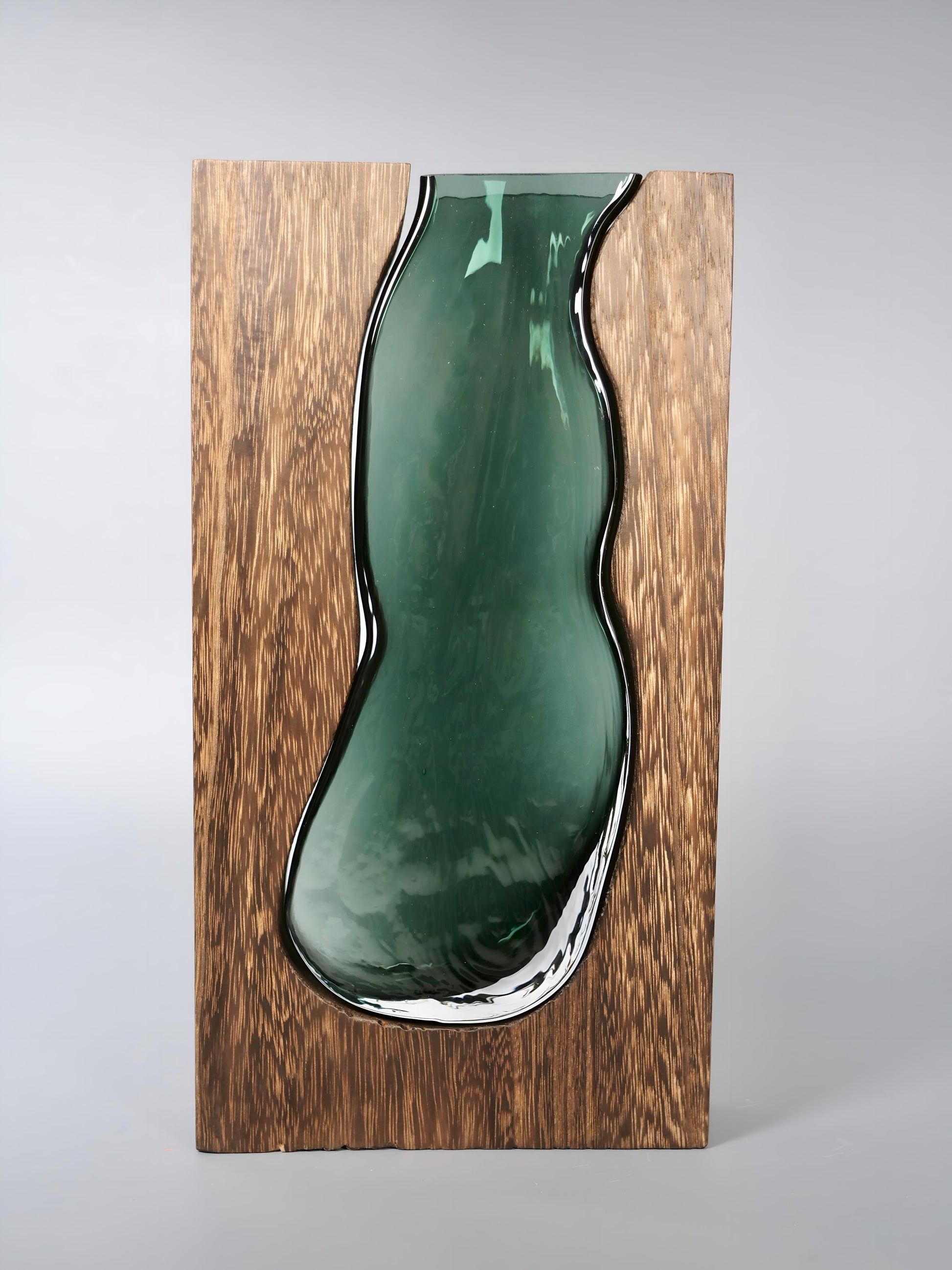 a green vase sitting on top of a wooden shelf 