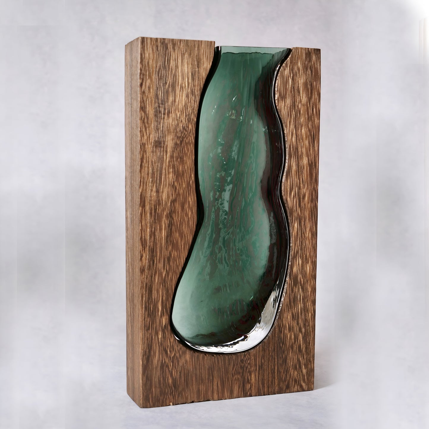 a green vase sitting on top of a wooden shelf 