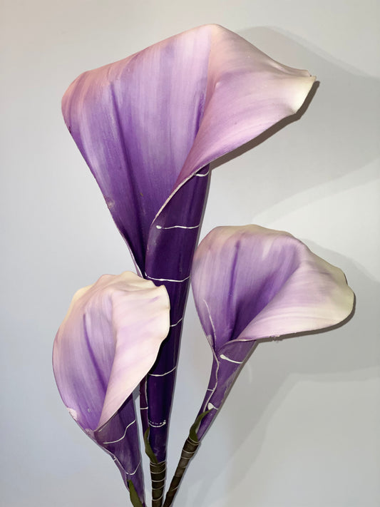 a purple flower in a pink flower in a pink vase 